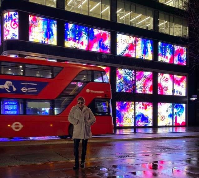 Helen outside Flannels, Oxford Street, London with her artwork on display called 'Dedication to the NHS' organised by W1 Curates