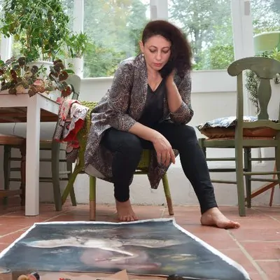 Iva Troj sitting in her studio