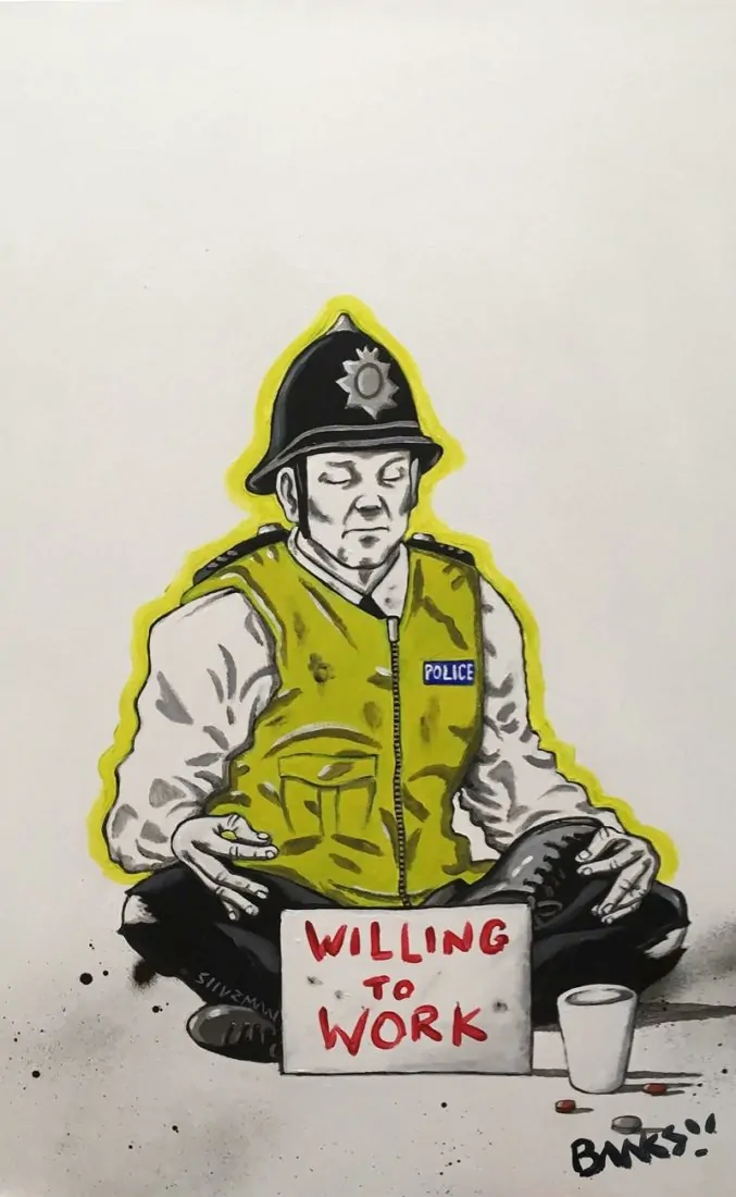 This art work shows a sleeping policeman with the sign 'willing to work'