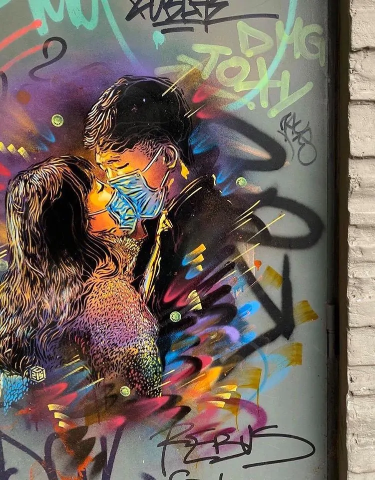 C215 depicts a loving couple wearing face masks