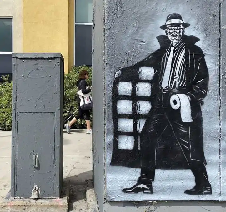 A street artist portrays a  dodgy character selling toilet roll