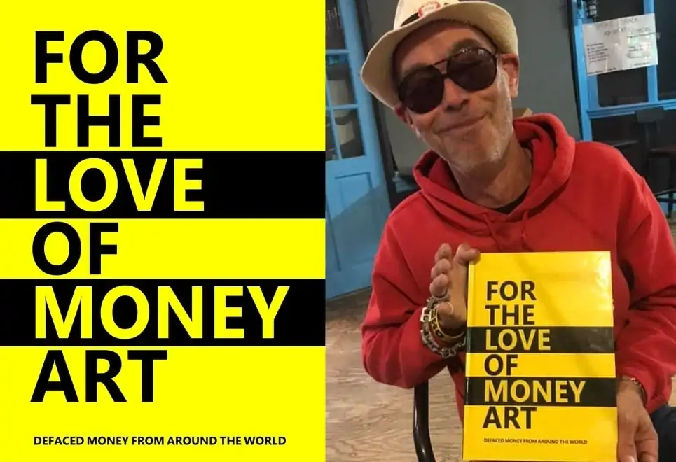 Darren Main proudly holds his book 'For The Love Of Money Art'