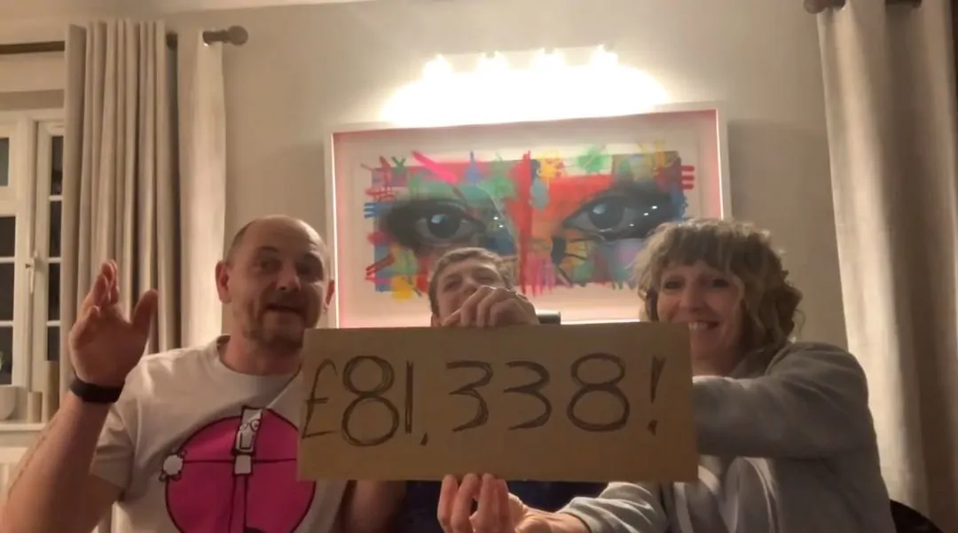 Noah, aka Background Bob with his mum and dad reveal the grand total raised from the auction
